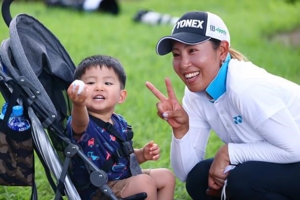 Maiko Wakaabayshi of Japan poses with a young fan after holing out during first round of the GMO Internet Ladies Samantha Thavasa Global Cup at Eagle...