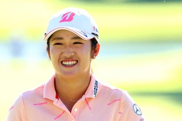 Mone Inami of Japan smiles after holing out on the 18th green during first round of the GMO Internet Ladies Samantha Thavasa Global Cup at Eagle...