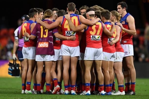 The Brisbane Lions huddle during the round 18 AFL match between the Richmond Tigers and the Brisbane Lions at Metricon Stadium on July 16, 2021 in...