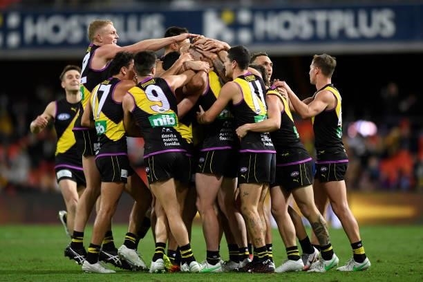 Jack Riewoldt of the Tigers celebrates with team mates after kicking the last goal of the match during the round 18 AFL match between the Richmond...