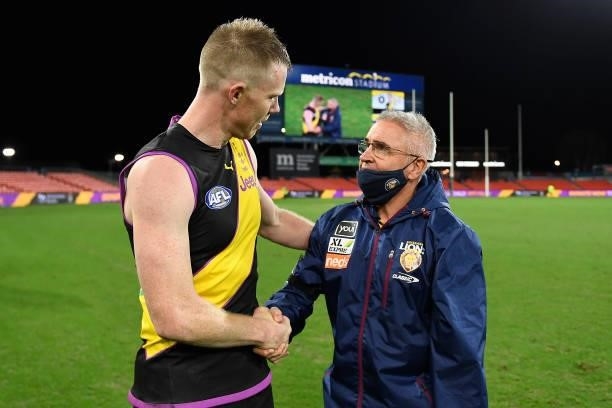 Jack Riewoldt of the Tigers is congratulated by Brisbane Lions coach Chris Fagan after playing his 300th match during the round 18 AFL match between...