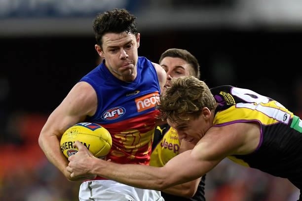 Lachie Neale of the Lions is tackled by Tom Lynch of the Tigers during the round 18 AFL match between the Richmond Tigers and the Brisbane Lions at...