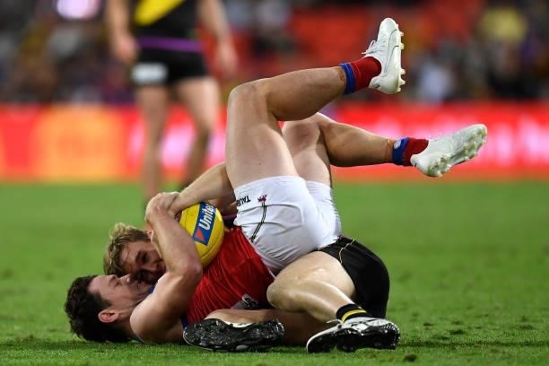 Lachie Neale of the Lions is tackled by Tom Lynch of the Tigers during the round 18 AFL match between the Richmond Tigers and the Brisbane Lions at...