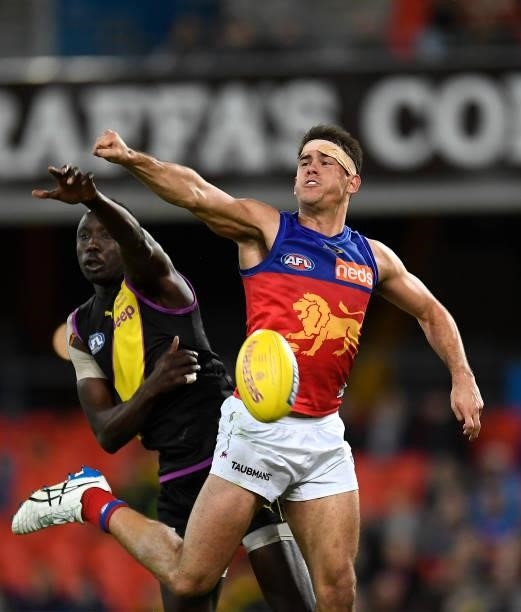 Mabior Chol of the Tigers and Brandon Starcevich of the Lions compete for the ball during the round 18 AFL match between the Richmond Tigers and the...