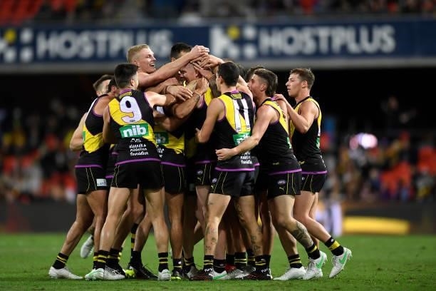 Jack Riewoldt of the Tigers celebrates with team mates after kicking the last goal of the match during the round 18 AFL match between the Richmond...