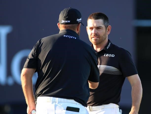 Shane Lowry of Ireland and Louis Oosthuizen of South Africa shake hands on the 18th green during Day Two of The 149th Open at Royal St George’s Golf...