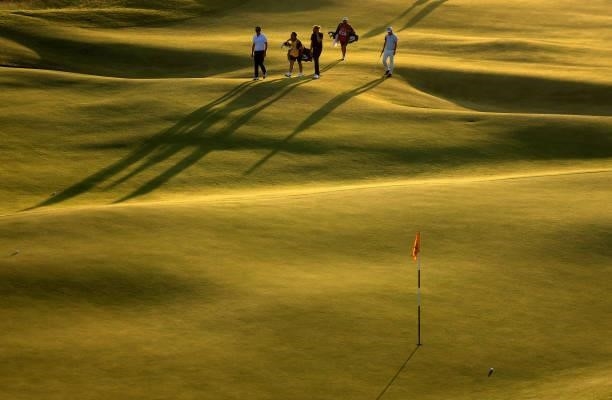 Lanto Griffin of The United States, Rikuya Hoskino of Japan and Connor Worsdall of England walk on the 15th hole during Day Two of The 149th Open at...