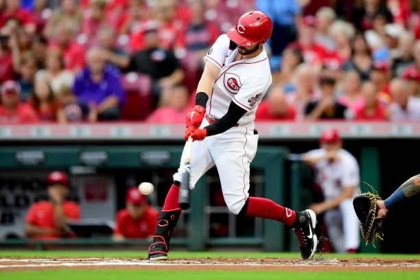 Tyler Naquin of the Cincinnati Reds hits a two-run RBI double in the first inning during their game against the Milwaukee Brewers at Great American...