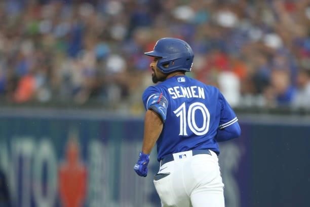 Marcus Semien of the Toronto Blue Jays watches his home run go over the fence during the third inning against the Texas Rangers at Sahlen Field on...