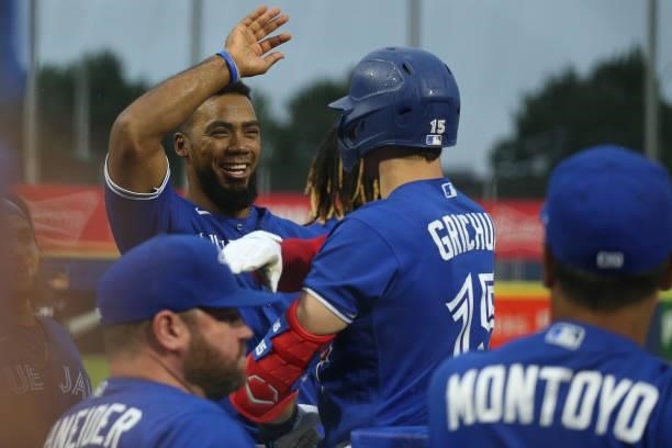 Teoscar Hernandez of the Toronto Blue Jays celebrates with Randal Grichuk of the Toronto Blue Jays after Grichuk hit a home run during the third...