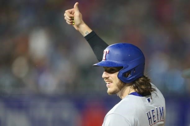 Jonah Heim of the Texas Rangers gives a thumbs-up to fans after hitting a single during the seventh inning against the Toronto Blue Jays at Sahlen...