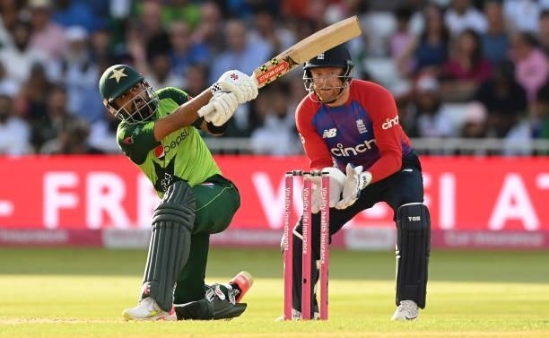 Babar Azam of Pakistan hits a six watched by Jonny Bairstow of England during the 1st Vitality T20 International between England and Pakistan at...