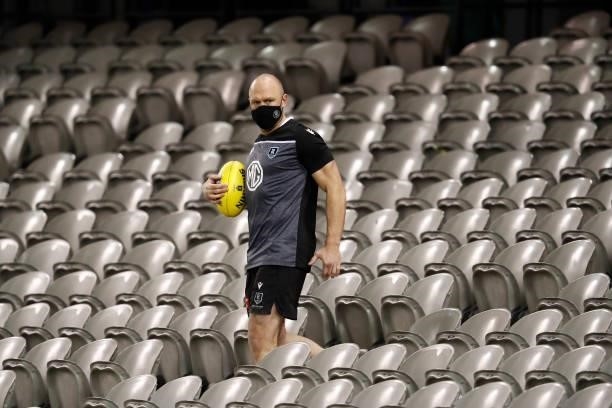 Port Adelaide Development coach Chad Cornes retrieves a ball from the stands where fans would normally be during the warm up before the round 18 AFL...