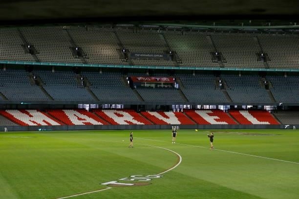 St Kilda players warm up in an empty stadium before the round 18 AFL match between St Kilda Saints and Port Adelaide Power at Marvel Stadium on July...