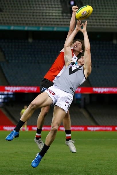 Leo Connolly of the Saints and Miles Bergman of the Power compete during the round 18 AFL match between St Kilda Saints and Port Adelaide Power at...
