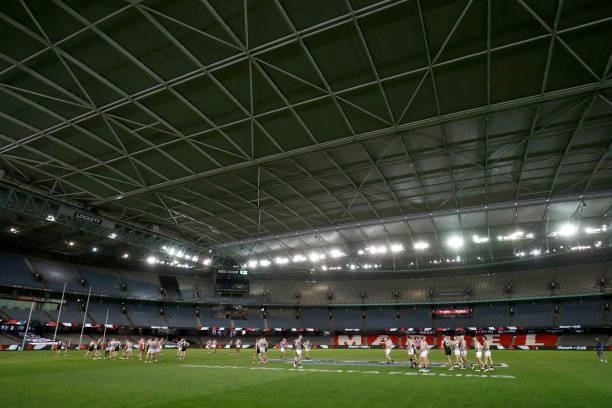 Players shake hands in a an empty stadium after the round 18 AFL match between St Kilda Saints and Port Adelaide Power at Marvel Stadium on July 17,...