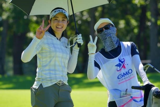 Sumika Nakasone of Japan poses with her caddie on the 15th hole during the second round of the GMO Internet Ladies Samantha Thavasa Global Cup at...