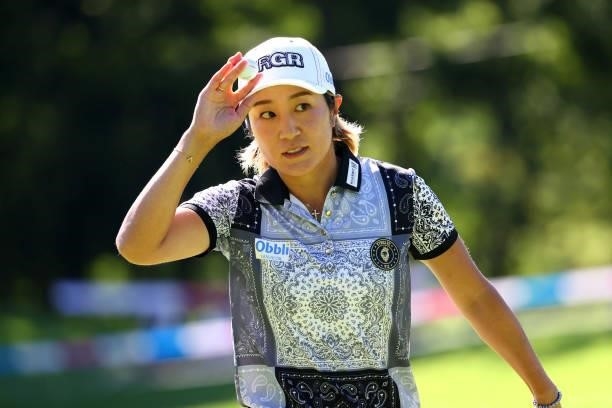Asako Fujimoto of Japan acknowledges fans after holing out with the birdie on the 18th green during the second round of the GMO Internet Ladies...