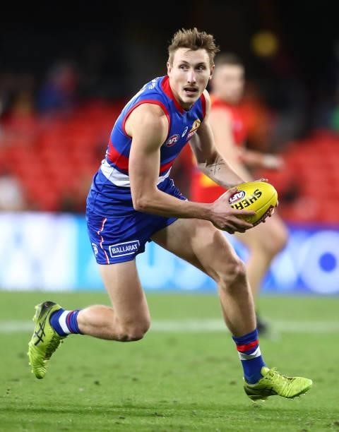 Bailey Dale of the Bulldogs runs with the ball during the round 18 AFL match between Gold Coast Suns and Western Bulldogs at Metricon Stadium on July...