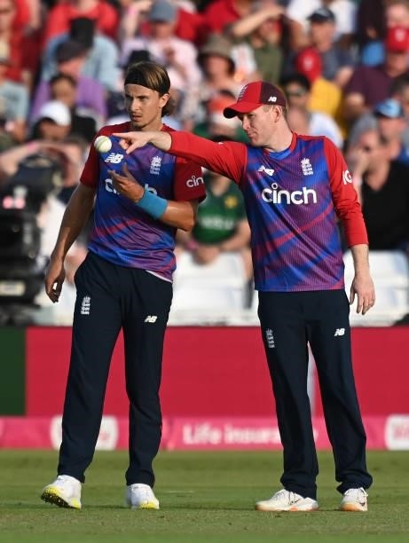 England captain Eoin Morgan talks with Tom Curran during the first Vitality International T20 match between England and Pakistan at Trent Bridge on...
