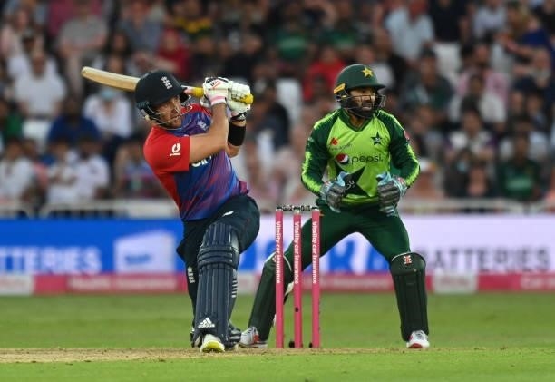 Liam Livinstone of England hits a six to reach his 100 as Pakistan wicket keeper Mohammad Rizwan looks on during the first Vitality International T20...