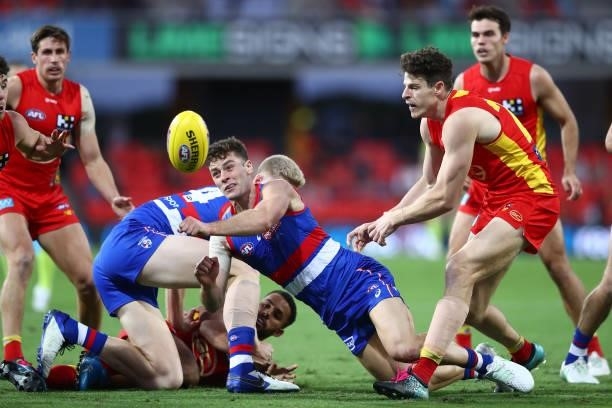 Josh Dunkley of the Bulldogs handballs during the round 18 AFL match between Gold Coast Suns and Western Bulldogs at Metricon Stadium on July 17,...