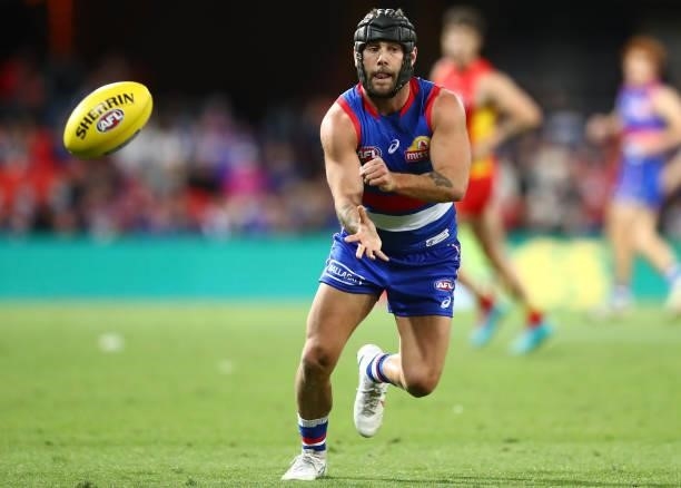 Caleb Daniel of the Bulldogs handballs during the round 18 AFL match between Gold Coast Suns and Western Bulldogs at Metricon Stadium on July 17,...