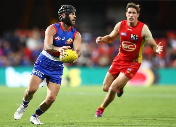 Caleb Daniel of the Bulldogs runs with the ball during the round 18 AFL match between Gold Coast Suns and Western Bulldogs at Metricon Stadium on...