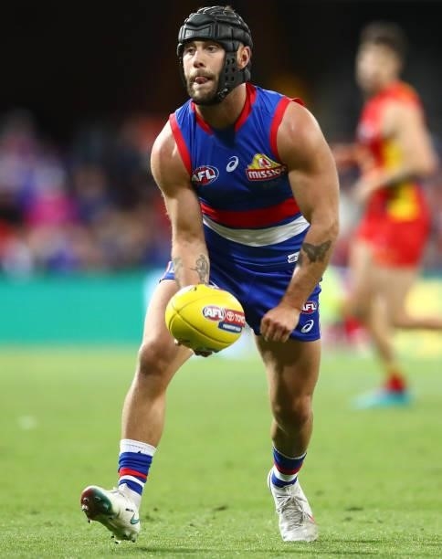 Caleb Daniel of the Bulldogs handballs during the round 18 AFL match between Gold Coast Suns and Western Bulldogs at Metricon Stadium on July 17,...