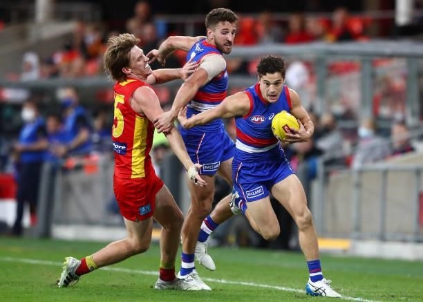 Riley Garcia of the Bulldogs runs with the ball during the round 18 AFL match between Gold Coast Suns and Western Bulldogs at Metricon Stadium on...
