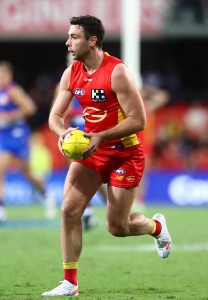 Rory Atkins of the Suns runs with the ball during the round 18 AFL match between Gold Coast Suns and Western Bulldogs at Metricon Stadium on July 17,...