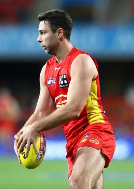 Rory Atkins of the Suns runs with the ball during the round 18 AFL match between Gold Coast Suns and Western Bulldogs at Metricon Stadium on July 17,...