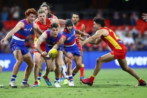 Josh Dunkley of the Bulldogs handballs during the round 18 AFL match between Gold Coast Suns and Western Bulldogs at Metricon Stadium on July 17,...