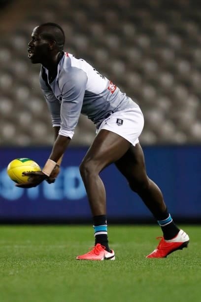 Aliir Aliir of the Power handballs during the round 18 AFL match between St Kilda Saints and Port Adelaide Power at Marvel Stadium on July 17, 2021...