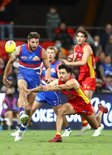 Marcus Bontempelli of the Bulldogs kicks the ball during the round 18 AFL match between Gold Coast Suns and Western Bulldogs at Metricon Stadium on...