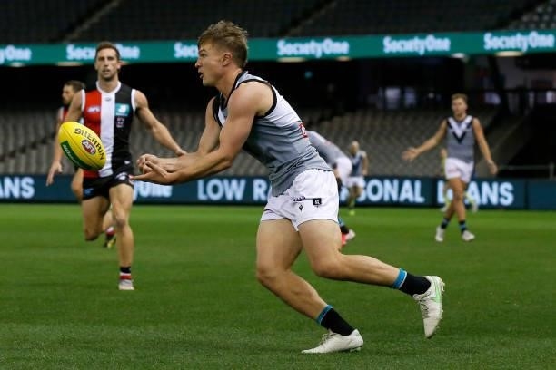 Ollie Wines of the Power handballs during the round 18 AFL match between St Kilda Saints and Port Adelaide Power at Marvel Stadium on July 17, 2021...