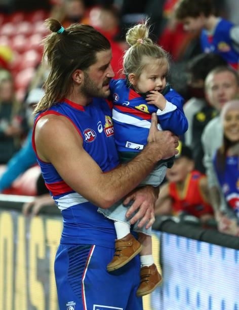 Josh Bruce of the Bulldogs is seen with his daughter Poppy, after the Bulldogs defeated the Suns during the round 18 AFL match between Gold Coast...