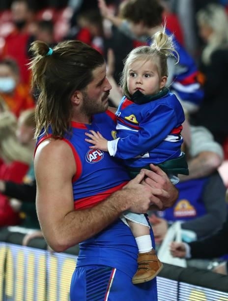 Josh Bruce of the Bulldogs is seen with his daughter Poppy, after the Bulldogs defeated the Suns during the round 18 AFL match between Gold Coast...
