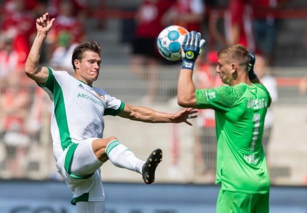 Kevin Behrens of 1.FC Union Berlin is challenged by goalkeeper Kevin Broll of Dynamo Dresden during the Pre-Season friendly match between 1. FC Union...