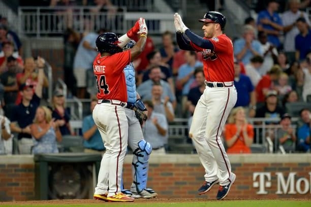Abraham Almonte and Freddie Freeman of the Atlanta Braves celebrate at home plate during a game against the Tampa Bay Rays at Truist Park on July 16,...