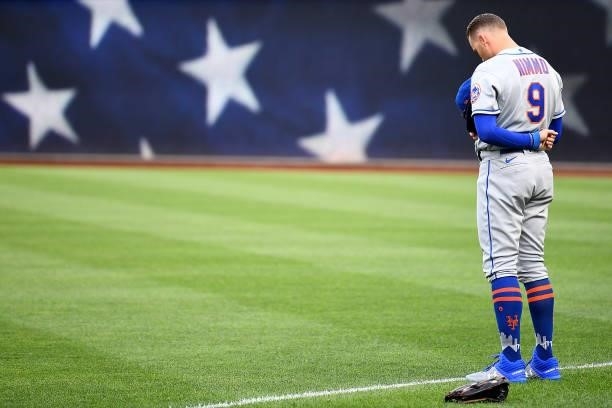 Brandon Nimmo of the New York Mets stands at attention for the playing of the National Anthem before the game against the Pittsburgh Pirates at PNC...