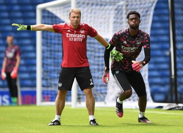 Arthur Okonkwo of Arsenal warms up with Inaki Cana Pavin the Arsenal goalkeeping coach before the pre season match between Glasgow Rangers and...