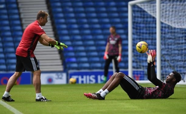 Arthur Okonkwo of Arsenal warms up with Inaki Cana Pavin the Arsenal goalkeeping coach before the pre season match between Glasgow Rangers and...