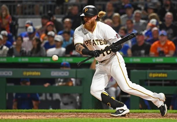 Ben Gamel of the Pittsburgh Pirates lays down a bunt during the game against the New York Mets at PNC Park on July 16, 2021 in Pittsburgh,...