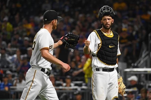 Chad Kuhl of the Pittsburgh Pirates fist bumps with Jacob Stallings during the game against the New York Mets at PNC Park on July 16, 2021 in...