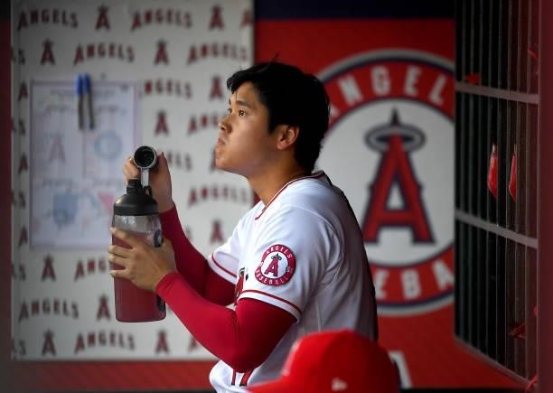 Shohei Ohtani of the Los Angeles Angels in the dugout during the game against the Seattle Mariners at Angel Stadium of Anaheim on July 16, 2021 in...