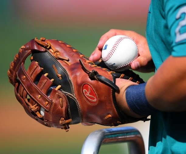 Detailed view of Ty France of the Seattle Mariners holding his glove and a ball before the game at Angel Stadium of Anaheim on July 16, 2021 in...