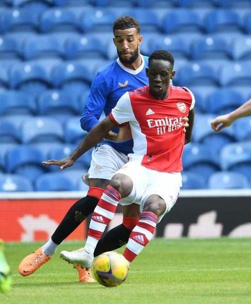 Flo Balogun of Arsenal challenged by Connor Goldson of Rangers during the pre season friendly between Rangers and Arsenal at Ibrox Stadium on July...