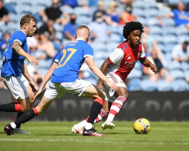Willian of Arsenal takes on Scott Airfield and Stephen Kelly of Rangers during the pre season friendly between Rangers and Arsenal at Ibrox Stadium...