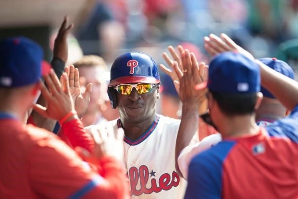 Didi Gregorius of the Philadelphia Phillies high fives his teammates after scoring a run against the Miami Marlins during Game One of the...